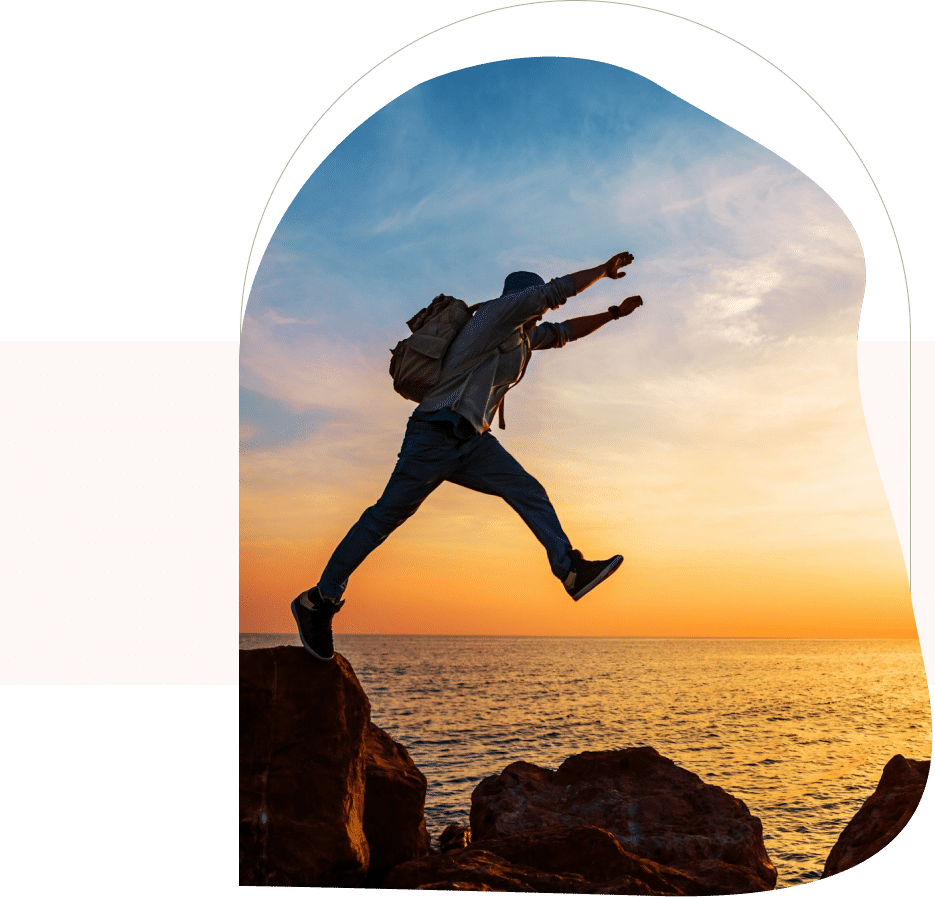 Person leaping over rocks at sunset, finding confidence and clarity through Depression Therapy San Francisco.