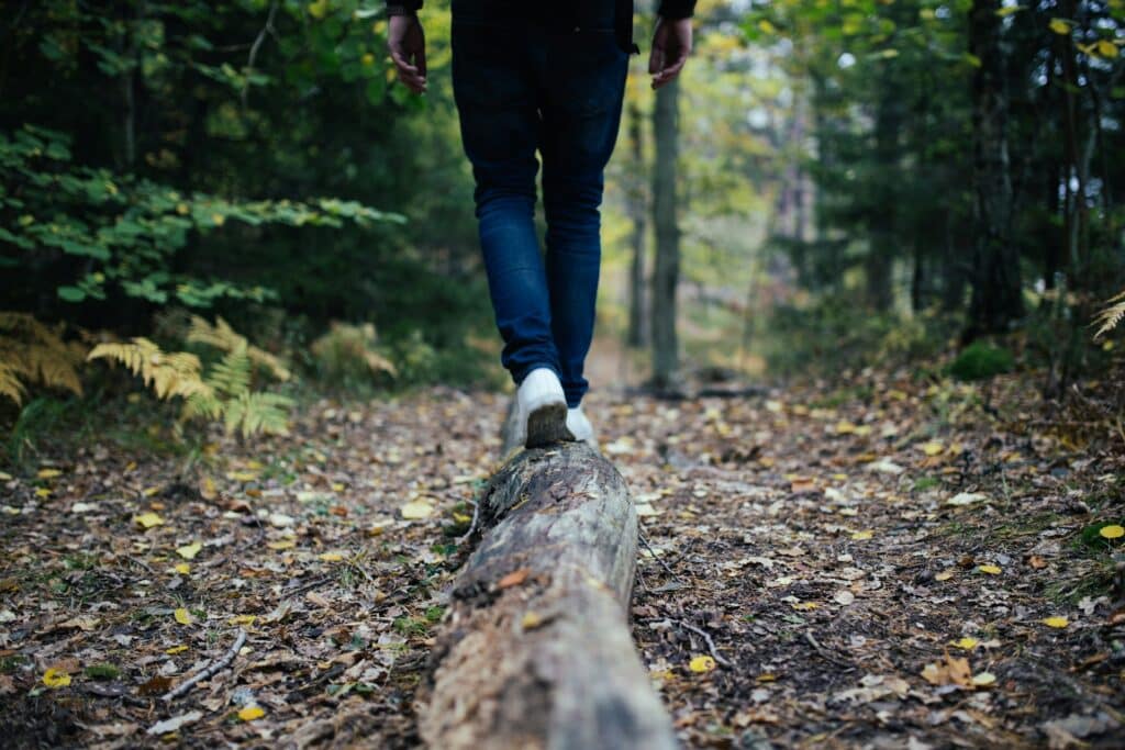 Walking on forest log, finding clarity and confidence with a CBT anxiety therapist in San Francisco.