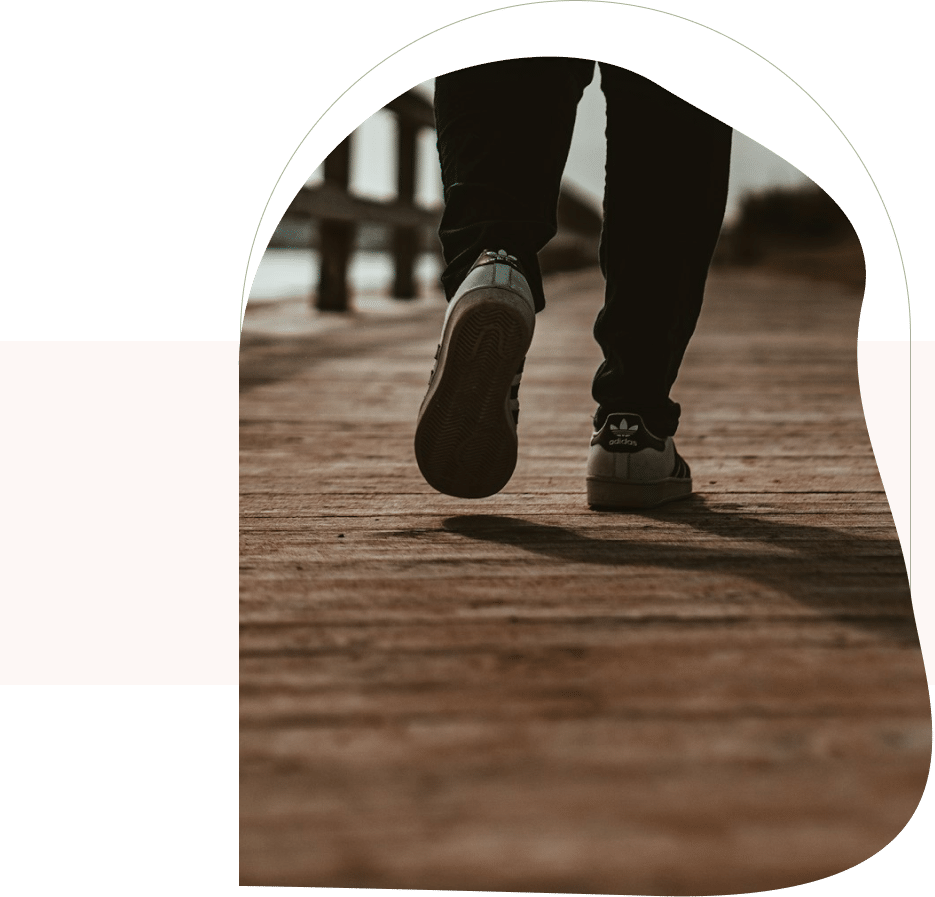 Feet walking on wooden path, symbolizing progress with CBT depression therapist in San Francisco.