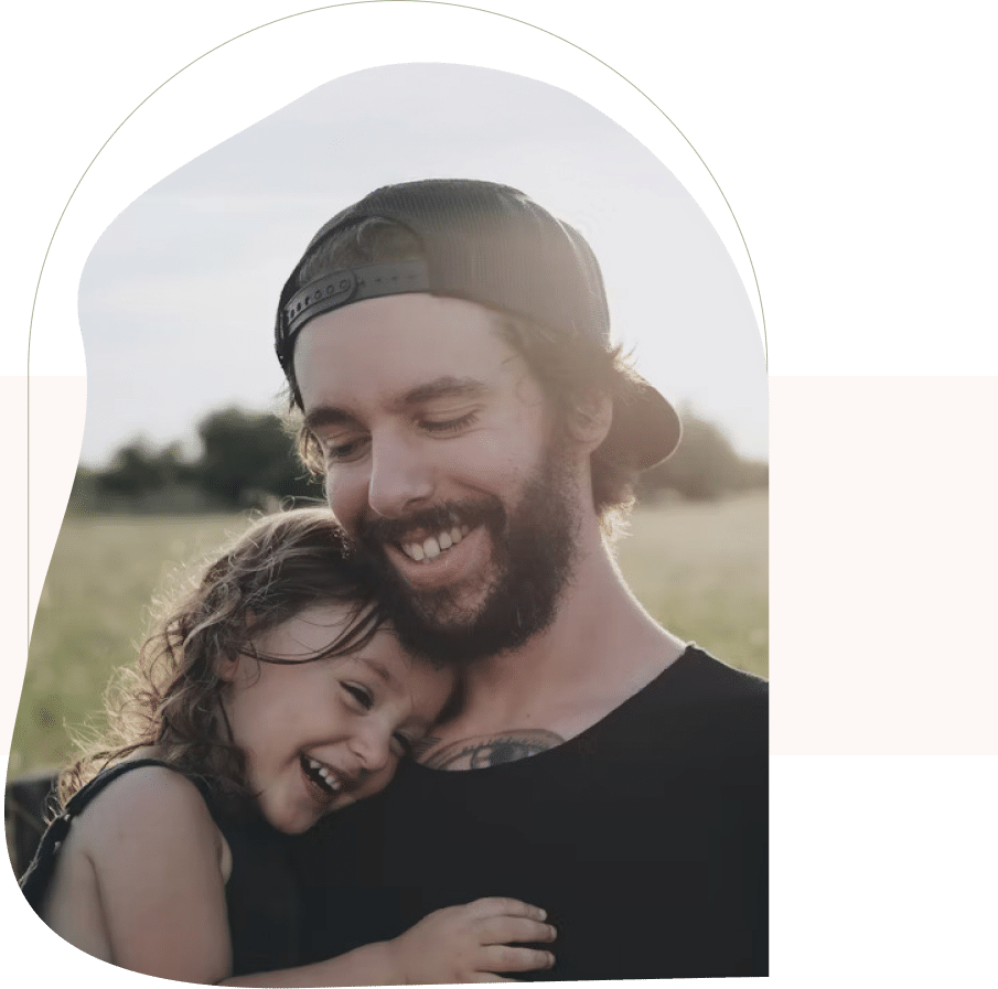 Man holding daughter outdoors, showing connection built through couples counseling for parents in San Francisco.