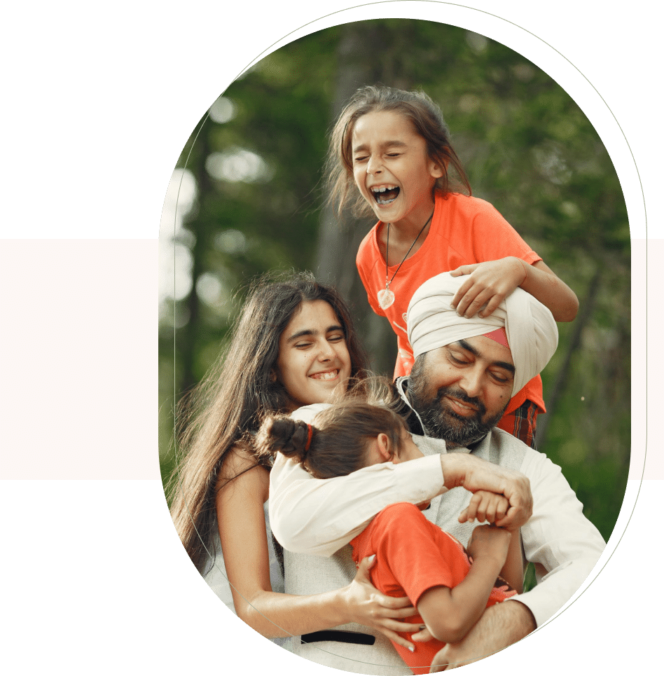 Happy family hugging and laughing outdoors, showing connection supported by family counseling San Francisco.