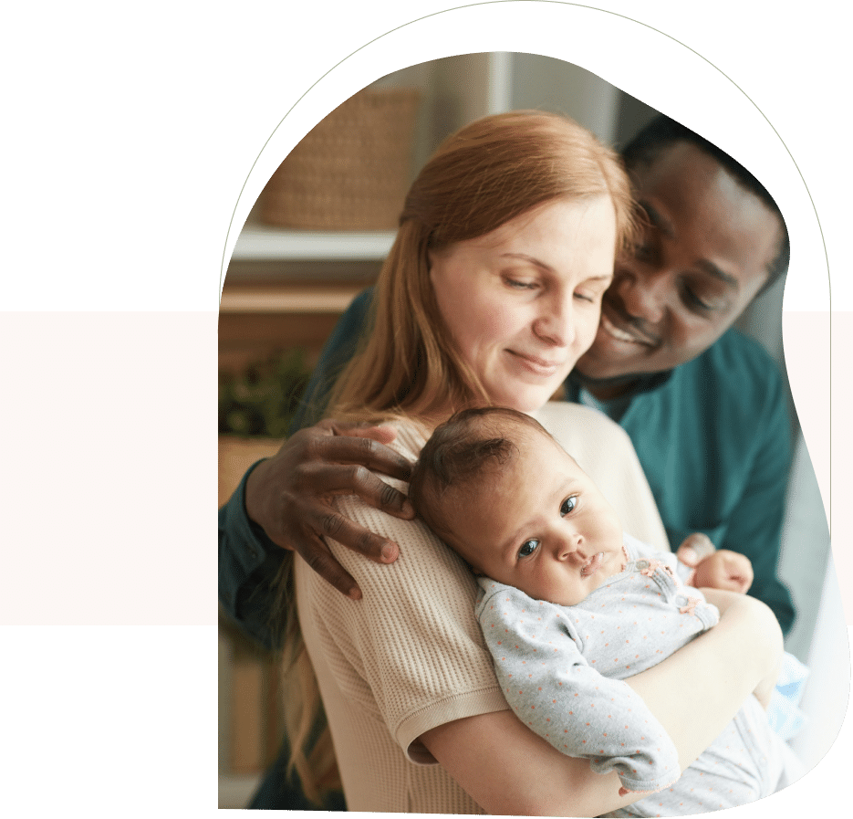 Smiling parents holding baby, symbolizing nurturing support and guidance through parenting coaching in San Francisco.