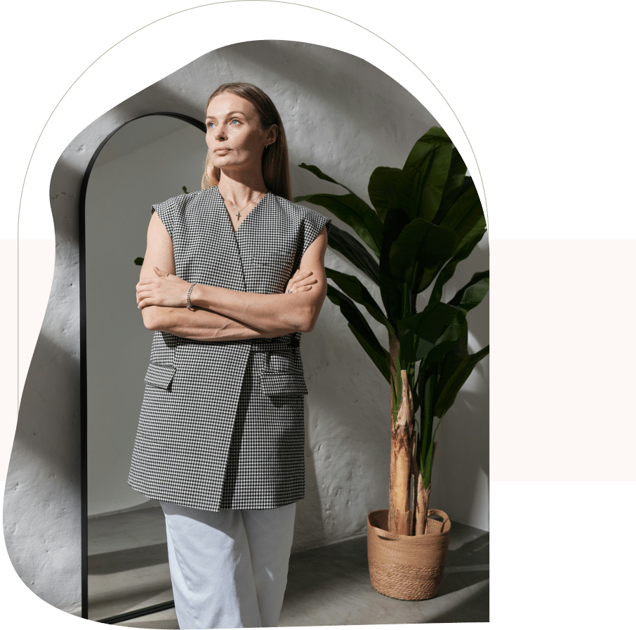 Woman standing with arms crossed, looking thoughtful after support from a therapist for depression in San Francisco.