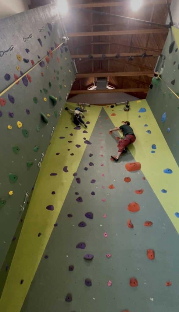 Climber scaling indoor wall, symbolizing steady progress with a CBT therapist in San Francisco for depression.