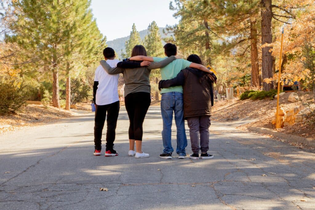 Group of teens walking with arms around each other, supported through therapy for teenagers in San Francisco.